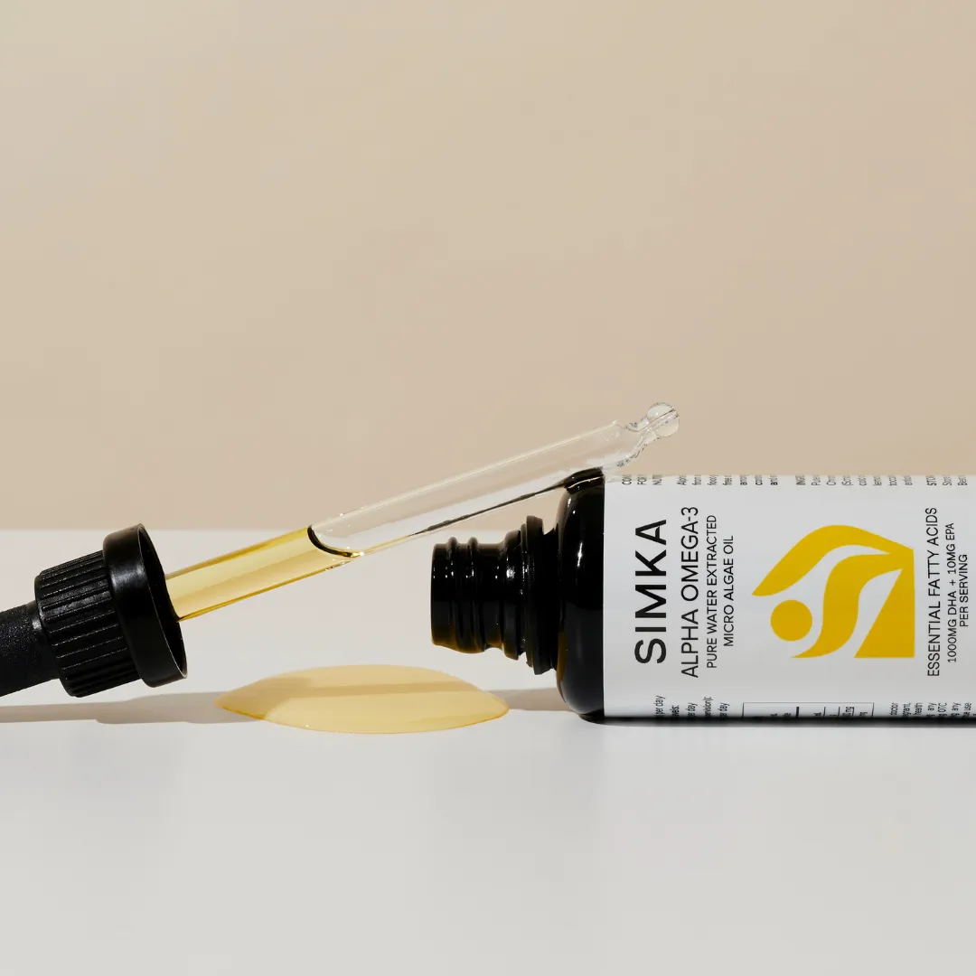 Omega-3 algae oil bottle with dropper and spill